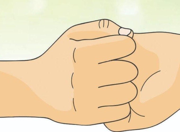 Ganesha Mudra hand gesture with fingers interlocked at the chest